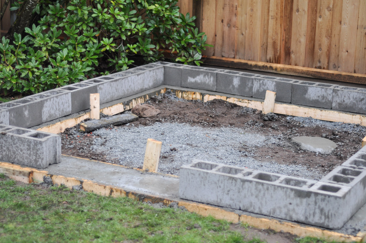 an image of a cinder block foundation being built for a greenhouse
